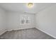 Simple bedroom with grey carpet and a window offering natural light at 5120 Tallwood Dr, Raleigh, NC 27613