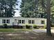 Single-wide manufactured home with brown trim and landscaping at 552 Sombrero Ln, Henderson, NC 27537