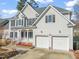 Two-story house with a double garage and manicured lawn at 5629 Beargrass Ln, Raleigh, NC 27616