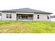 View of the home's backyard showcasing a covered patio and green space at 565 Sweet Potato Lane # 07, Nashville, NC 27856