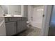 Well-lit bathroom with a gray vanity, white countertop, and shower-tub combination at 565 Sweet Potato Lane # 07, Nashville, NC 27856