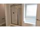 Elegant bathroom featuring a glass shower enclosure and a bright window-lit bathtub at 565 Sweet Potato Lane # 07, Nashville, NC 27856