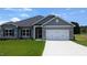 Charming single-story home with a two-car garage, gray siding, and manicured lawn at 565 Sweet Potato Lane # 07, Nashville, NC 27856