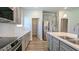Spacious kitchen with stainless appliances, subway tile backsplash, and gray cabinetry at 565 Sweet Potato Lane # 07, Nashville, NC 27856
