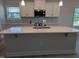 Large kitchen island with quartz countertops, stainless appliances, and white cabinetry is excellent for entertaining at 565 Sweet Potato Lane # 07, Nashville, NC 27856