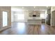 Open-concept kitchen with gray cabinets, a large island, wood floors, and modern lighting at 565 Sweet Potato Lane # 07, Nashville, NC 27856