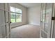 Cozy office with french doors, a large window with wooded yard views, and neutral carpet at 565 Sweet Potato Lane # 07, Nashville, NC 27856