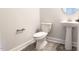 This powder room features a pedestal sink, toilet, and neutral wall paint color at 565 Sweet Potato Lane # 07, Nashville, NC 27856