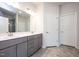 Bathroom with double vanity, gray cabinets, and a large mirror at 60 Watermelon Dr, Franklinton, NC 27525
