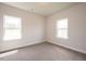 Well-lit bedroom with two windows and carpeted floors at 60 Watermelon Dr, Franklinton, NC 27525