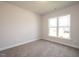 Bright bedroom with carpeted floor and a large window at 60 Watermelon Dr, Franklinton, NC 27525