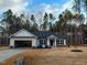 Newly constructed house with a two-car garage and landscaped lawn at 60 Watermelon Dr, Franklinton, NC 27525