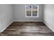 Bright bedroom with wood-look floors and a large window at 610 Lockwood Dr, Clayton, NC 27527