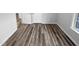 Simple bedroom with wood-look floors and access to other rooms at 610 Lockwood Dr, Clayton, NC 27527