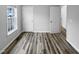 Spacious bedroom featuring wood-look floors and multiple doors at 610 Lockwood Dr, Clayton, NC 27527