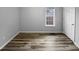Well-lit bedroom, showcasing wood-look floors and a window at 610 Lockwood Dr, Clayton, NC 27527