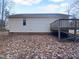 House exterior showcasing a deck and yard with leaf covered ground at 610 Lockwood Dr, Clayton, NC 27527
