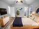 Virtually staged main bedroom with ensuite bathroom and wood-look floors at 610 Lockwood Dr, Clayton, NC 27527