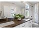 Bright bathroom featuring a double sink vanity and shower-tub combination at 700 Coleman St, Raleigh, NC 27610