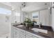 Bright bathroom featuring double sinks, quartz countertops, and a marble-tiled walk-in shower at 700 Coleman St, Raleigh, NC 27610