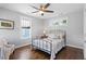 Cozy bedroom with hardwood floors, fan and metal bed frame at 700 Coleman St, Raleigh, NC 27610
