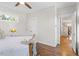 Comfortable bedroom featuring hardwood floors, neutral walls, and a tray with snacks on the bed at 700 Coleman St, Raleigh, NC 27610