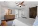 Cozy bedroom with a ceiling fan, barn door, and an adjacent bathroom at 700 Coleman St, Raleigh, NC 27610