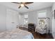 Well-lit bedroom featuring a fan, hardwood floors, and neutral decor at 700 Coleman St, Raleigh, NC 27610