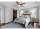 Bedroom showcasing neutral colors, a ceiling fan, and a sliding barn door at 700 Coleman St, Raleigh, NC 27610