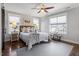Inviting bedroom with multiple windows, comfortable bedding, and an area rug on hardwood floors at 700 Coleman St, Raleigh, NC 27610