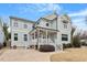 Charming two-story home with a covered front porch, manicured landscaping, and light-colored siding at 700 Coleman St, Raleigh, NC 27610
