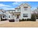 Beautiful two story home with white trim, light colored siding, and a cozy front porch at 700 Coleman St, Raleigh, NC 27610