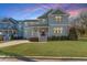 Charming two-story home with a covered front porch and lush green lawn at 700 Coleman St, Raleigh, NC 27610