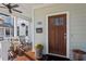 Inviting front porch with wood door, hanging plants, and seating at 700 Coleman St, Raleigh, NC 27610