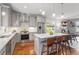 Bright, open kitchen with gray cabinets, stainless appliances, and large island at 700 Coleman St, Raleigh, NC 27610