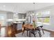Bright kitchen features stainless appliances, gray cabinets, and island with bar stool seating at 700 Coleman St, Raleigh, NC 27610