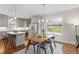Open kitchen and dining area with gray cabinets, stainless appliances, and island with seating at 700 Coleman St, Raleigh, NC 27610