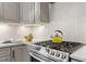 Kitchen with stainless steel stove with cooktop and herringbone tile backsplash at 700 Coleman St, Raleigh, NC 27610