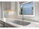 Modern stainless steel kitchen sink with view from window at 700 Coleman St, Raleigh, NC 27610