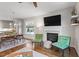 Bright living room with a fireplace, comfortable seating, and hardwood floors at 700 Coleman St, Raleigh, NC 27610