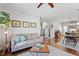 Open-concept living room with hardwood floors, a comfortable sofa, and a view of the kitchen at 700 Coleman St, Raleigh, NC 27610