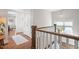 Well-lit staircase landing with wood floors and white trim, leading to additional rooms at 700 Coleman St, Raleigh, NC 27610