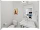 Elegant powder room features a modern sink, sleek fixtures, and artistic wall decor with a neutral color palette at 712 E Edenton St # 105, Raleigh, NC 27601