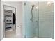 Stylish bathroom featuring a glass-enclosed shower with subway tile and a closet with custom shelving at 712 E Edenton St # 105, Raleigh, NC 27601