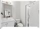 Bright bathroom featuring modern vanity with sink, toilet, and walk-in shower with glass door at 712 E Edenton St # 105, Raleigh, NC 27601