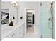 Elegant bathroom showcasing double sinks, a glass-enclosed shower, and a closet with custom shelving at 712 E Edenton St # 105, Raleigh, NC 27601