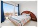 Bedroom showcasing a large window offering abundant natural light, and a decorative, colorful bedspread at 712 E Edenton St # 105, Raleigh, NC 27601