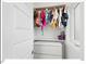 Well-organized closet featuring hanging clothes, shelving and storage, and a window for natural light at 712 E Edenton St # 105, Raleigh, NC 27601
