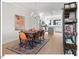 Bright dining area features hardwood floors, stylish chandelier, and an open-concept design to the kitchen at 712 E Edenton St # 105, Raleigh, NC 27601