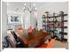 Bright dining area features hardwood floors, stylish chandelier, shelving, and an open-concept design to the kitchen at 712 E Edenton St # 105, Raleigh, NC 27601